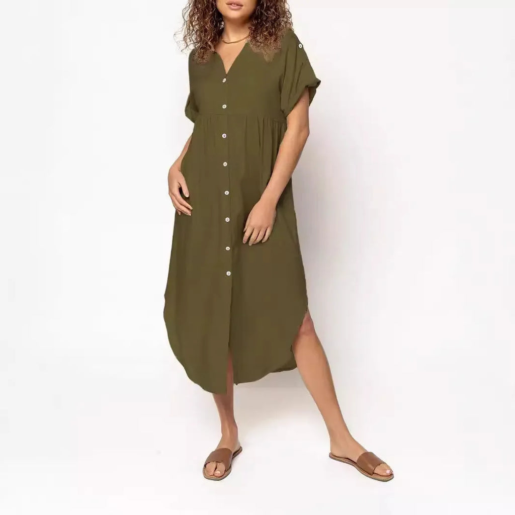 A woman wearing a loose-fitting, mid-length apricot-coloured casual dress with a button-down front.