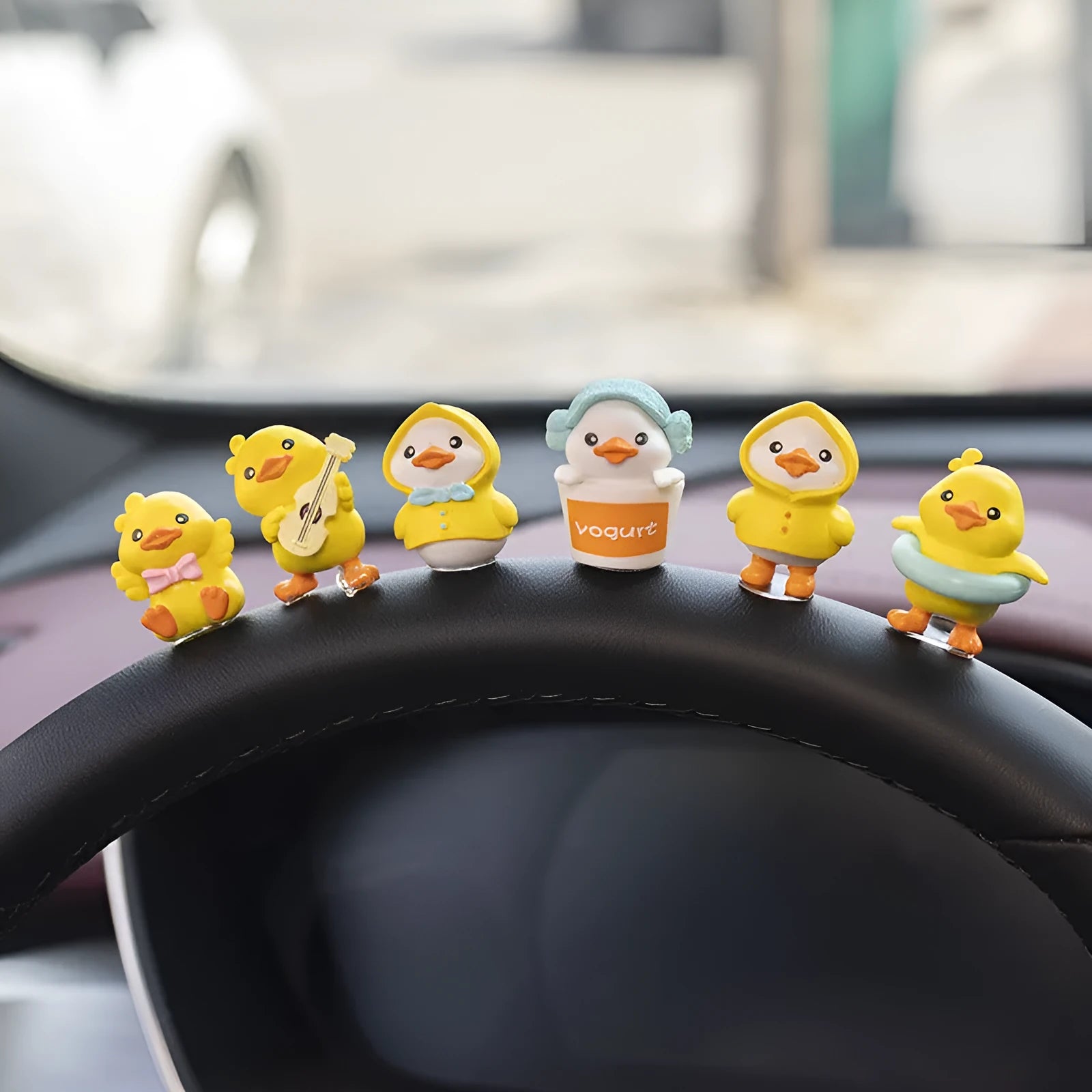 Set of six small yellow PVC duck figurines and one plastic sign for car dashboard decoration.