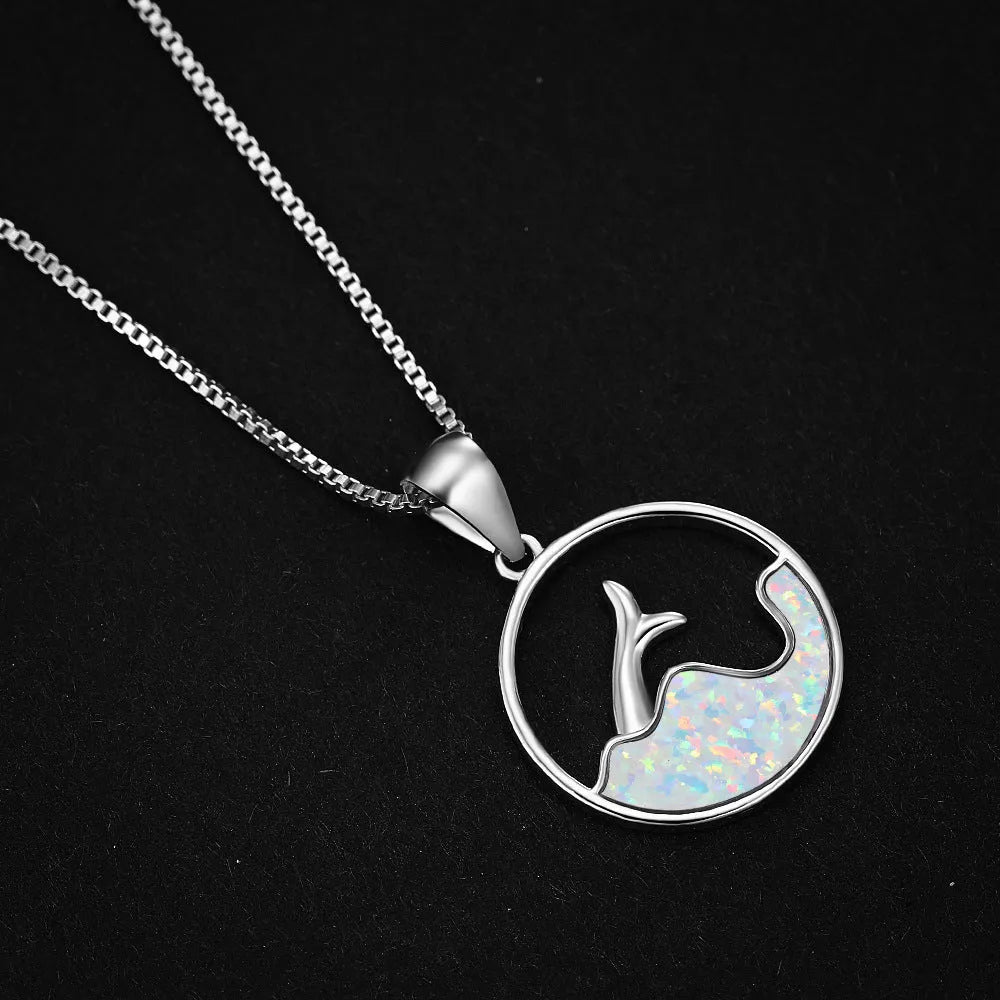 A geometric round opal pendant necklace with a fishtail design on a chain.