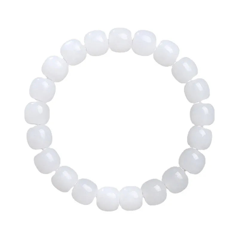 White Hetian jade barrel bead bracelet on a wrist, showing unisex casual style