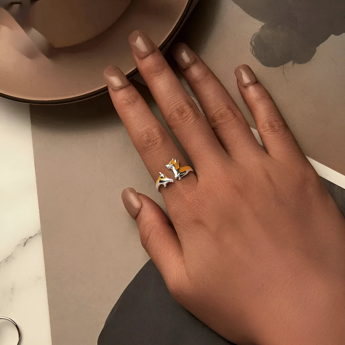 Adjustable silver ring with a raised cartoon corgi dog design on the band.