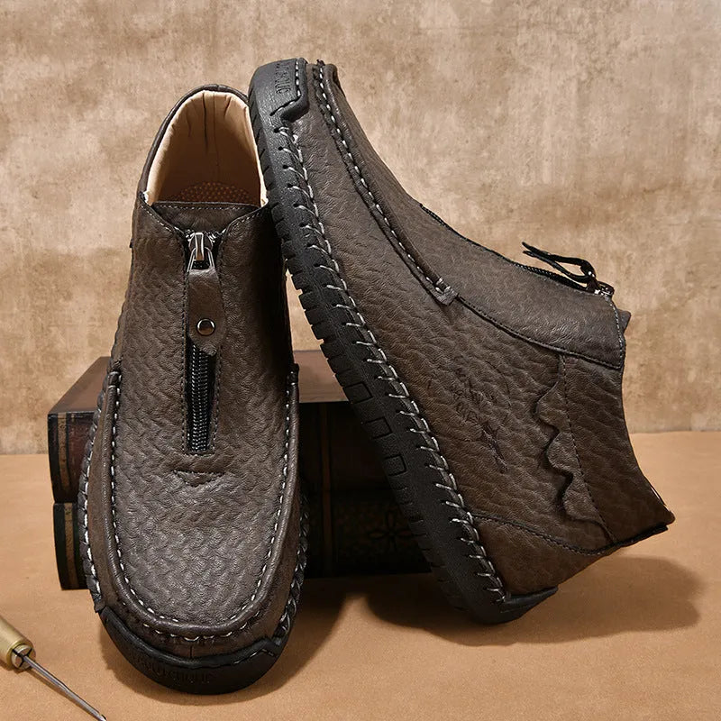 Men's black slip-on loafers with a round toe and rubber sole on a white background.