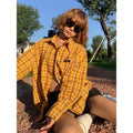 Loose-fitting dopamine yellow plaid cardigan-style shirt on a hanger