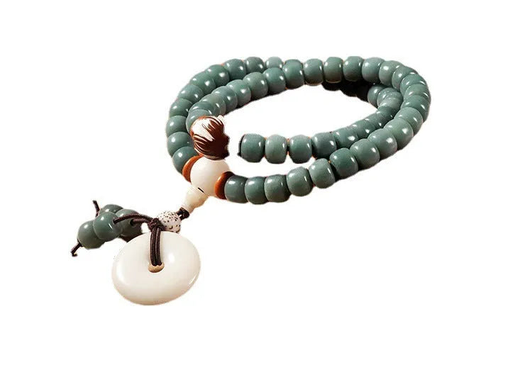 Bodhi seed bracelet with double ring safety buckle and lotus design on round beads