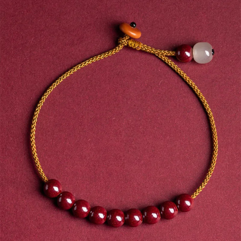 Hand-woven geometric bracelet made from raw cinnabar and Hetian jade beads