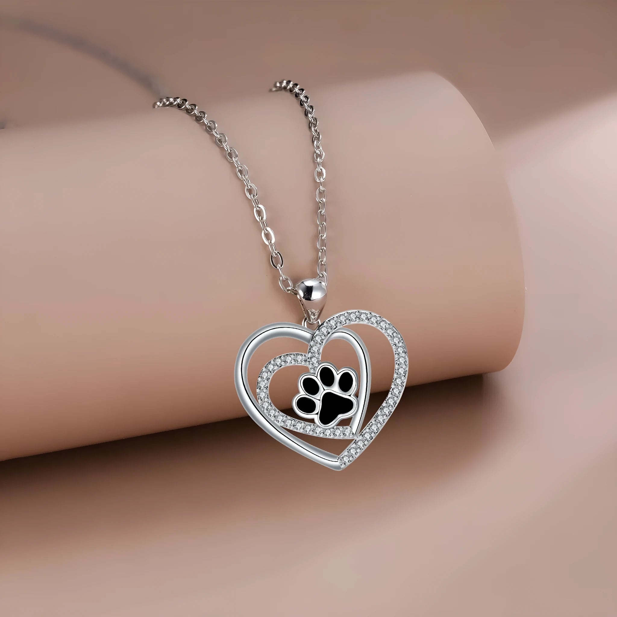 Original design heart-shaped copper necklace with a detailed dog paw print pendant on a cross chain.