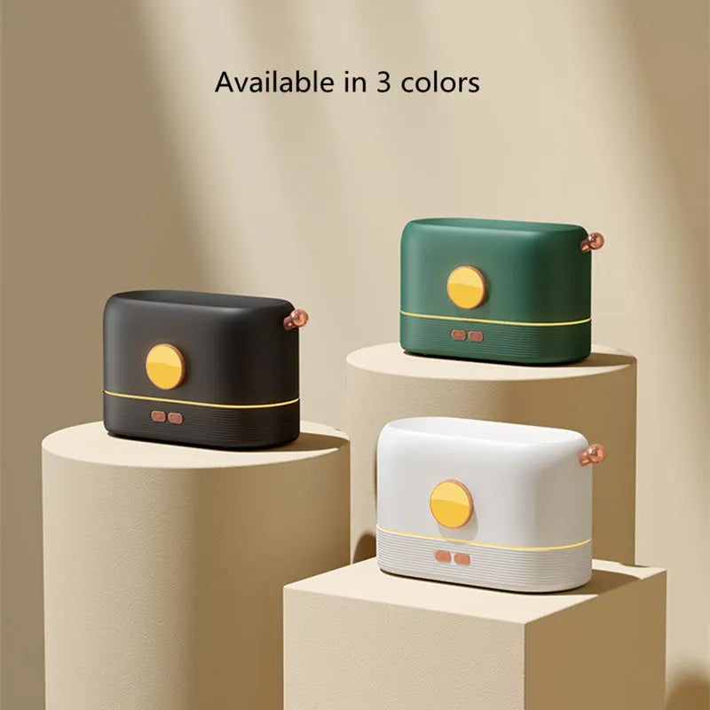 Black USB desktop humidifier diffuser with glowing simulated flame effect on a wooden table.