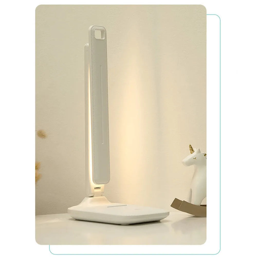 White plastic LED table lamp with touch dimming controls for bedside use