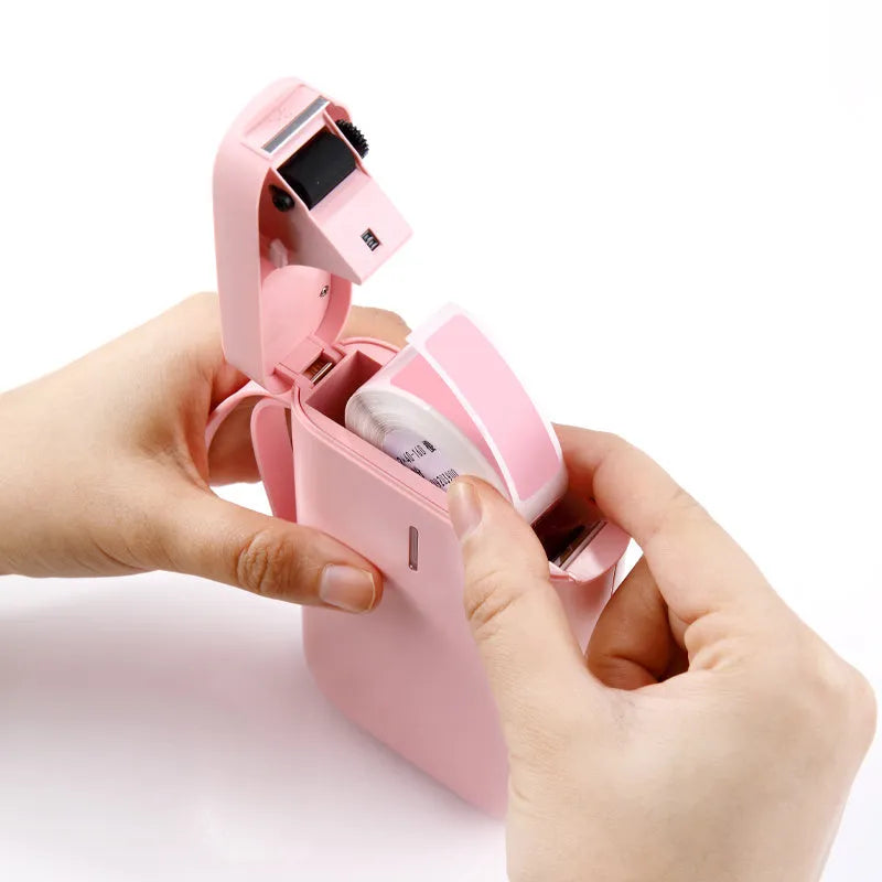 Compact D11 Bluetooth thermal label printer in black, with smartphone showing label design app.