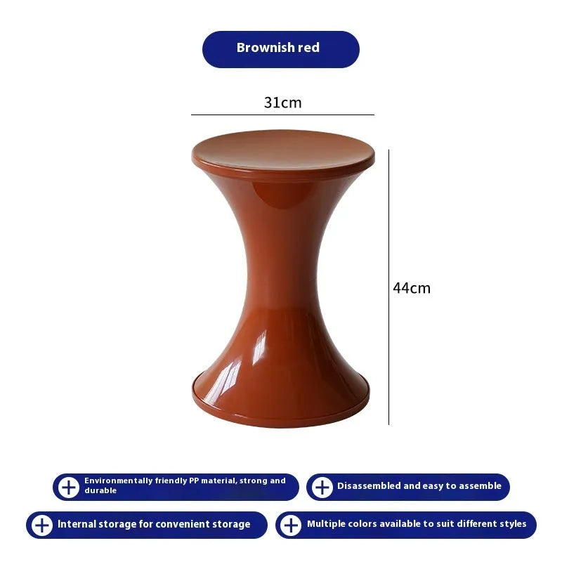 Hourglass-shaped plastic shoe changing stool in green, shown as a step aid.