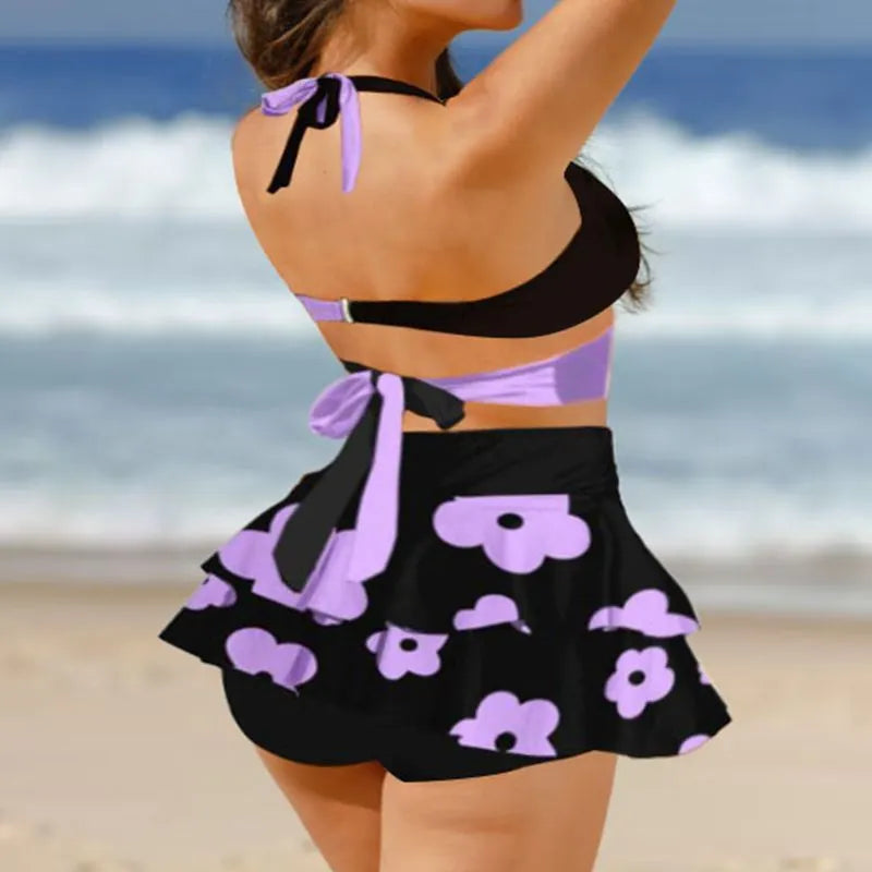 Purple women's high-waisted bikini swimsuit with skirt overlay and lace-up back detail