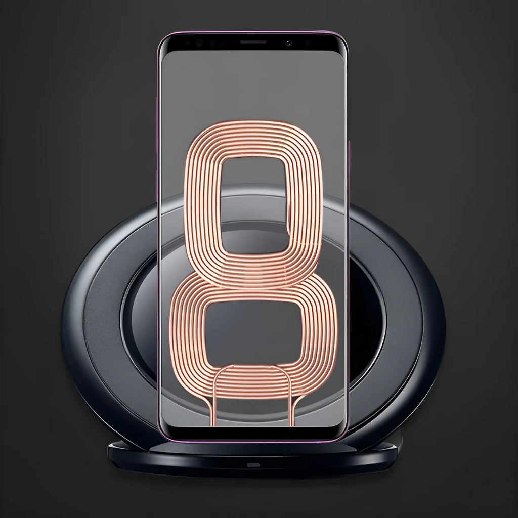 A black or white wireless charging pad for a Samsung Galaxy Note Edge mobile phone on a desk.