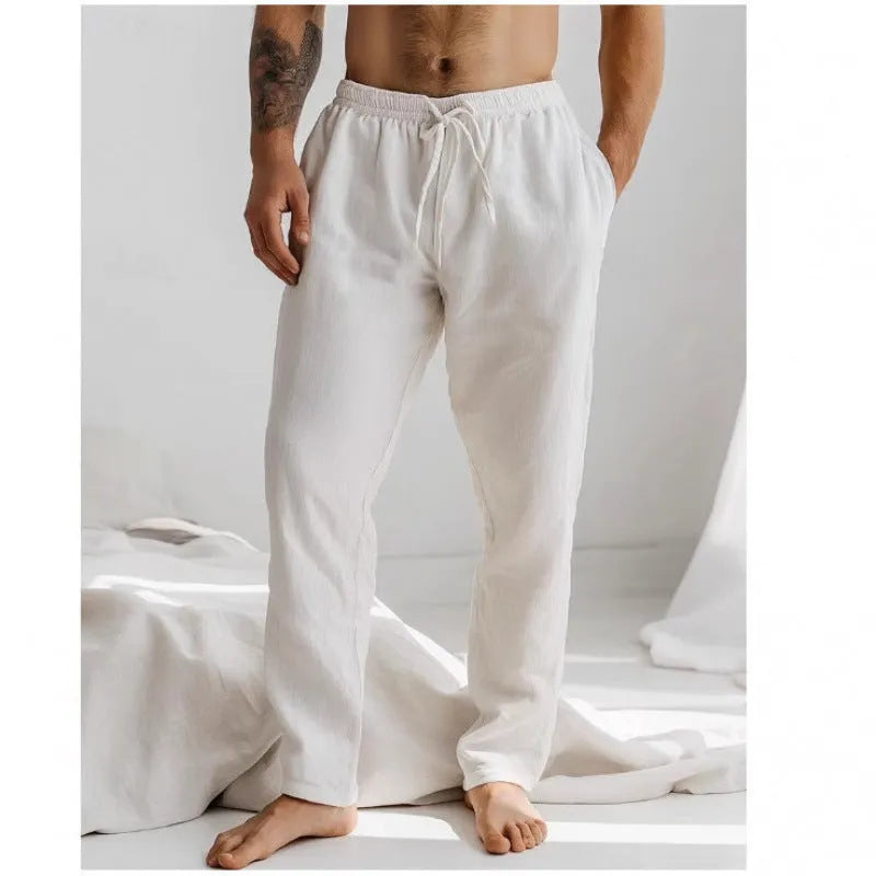 Man wearing light blue loose-fit cotton linen trousers with an elastic drawstring waist.