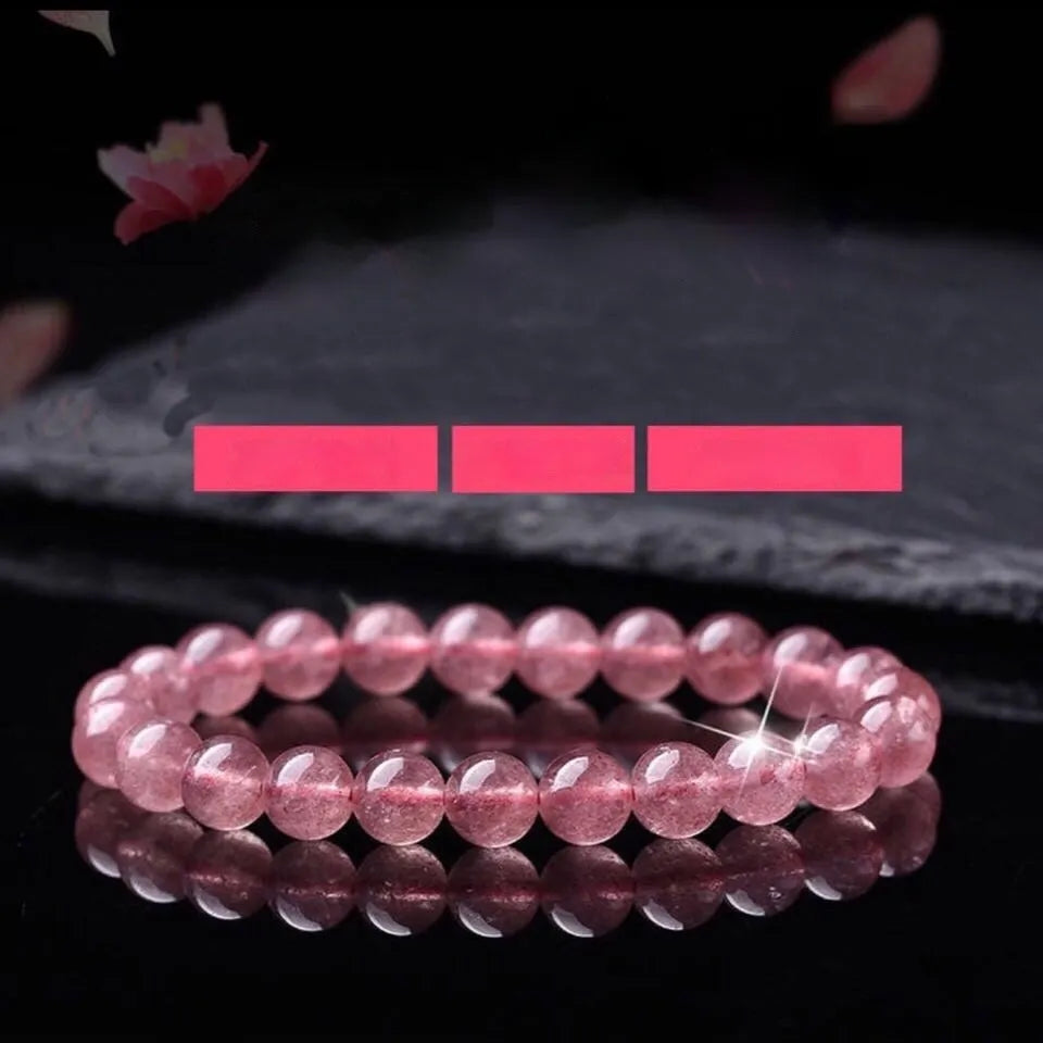Women's strawberry quartz crystal bracelet with polished beads in 6mm, 8mm, and 10mm sizes
