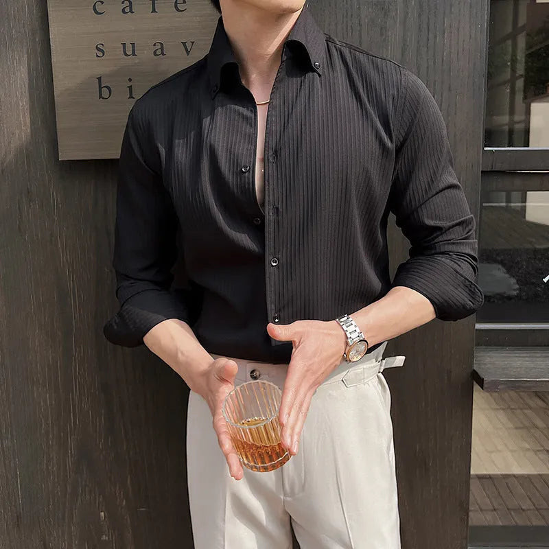 Man wearing a dark striped V-neck long sleeve shirt in a cardigan style.