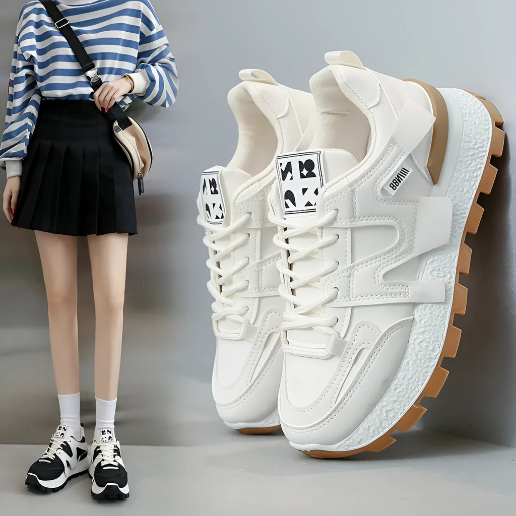 Women's white low-top running sneakers with round toe and lace-up closure on rubber sole