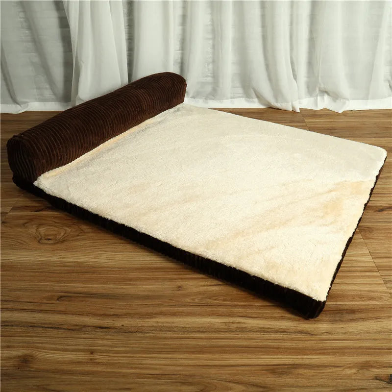 Corduroy pet sofa dog bed with bolster, shown in a grey colour on a wooden floor.