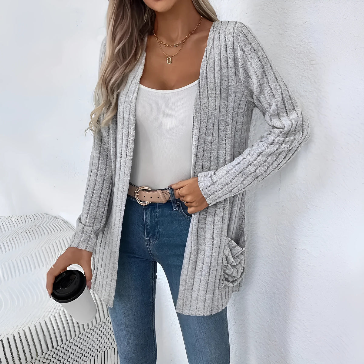 Men's loose fit grey long sleeve cardigan with a pocket, shown on a hanger.