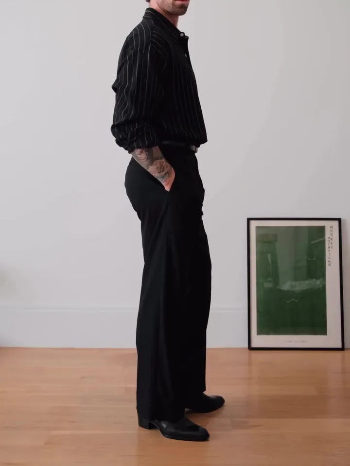 Black pinstriped button-down polyester shirt with a regular fit on a hanger.