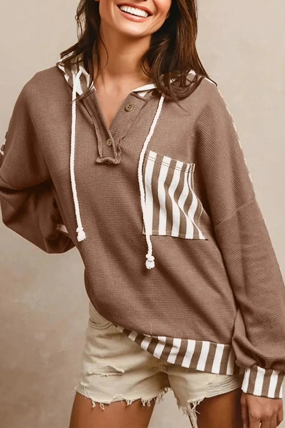 Straw yellow waffle texture hoodie with patchwork stripes, drawstring hood, and button neck detail