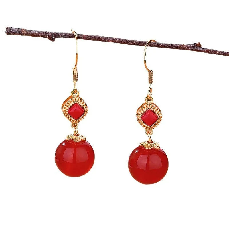 Geometric silver-plated earrings with round red agate beads and green jasper stone inlays.