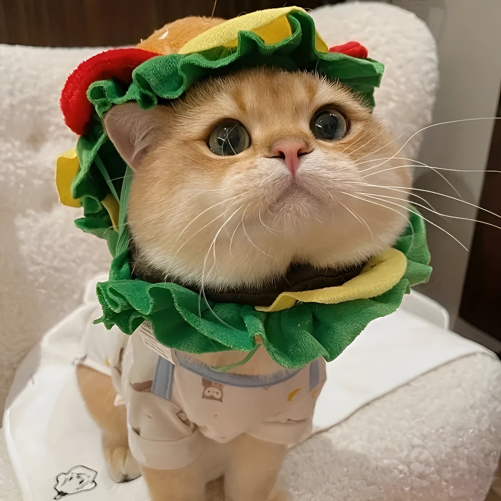 Yellow burger headdress for cats with fabric lettuce and cheese details on adjustable elastic band