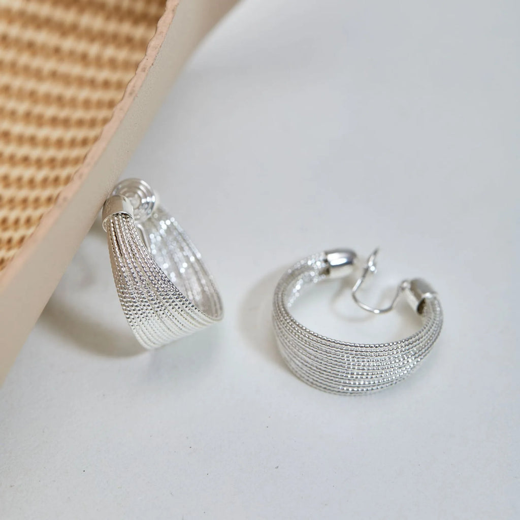 Geometric multi-layer copper earrings with silver or gold electroplated finish, showing stud and clip options