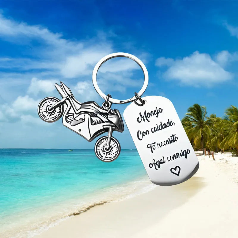 Stainless steel motorcycle keychain with inspirational text and a flannel storage bag.