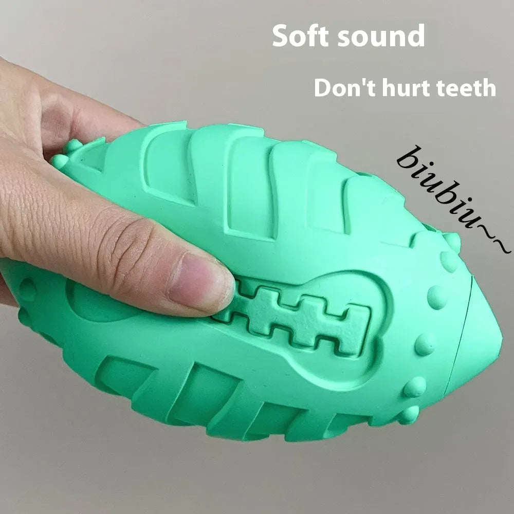Light green rubber rugby ball dog chew toy with textured surface for teeth cleaning