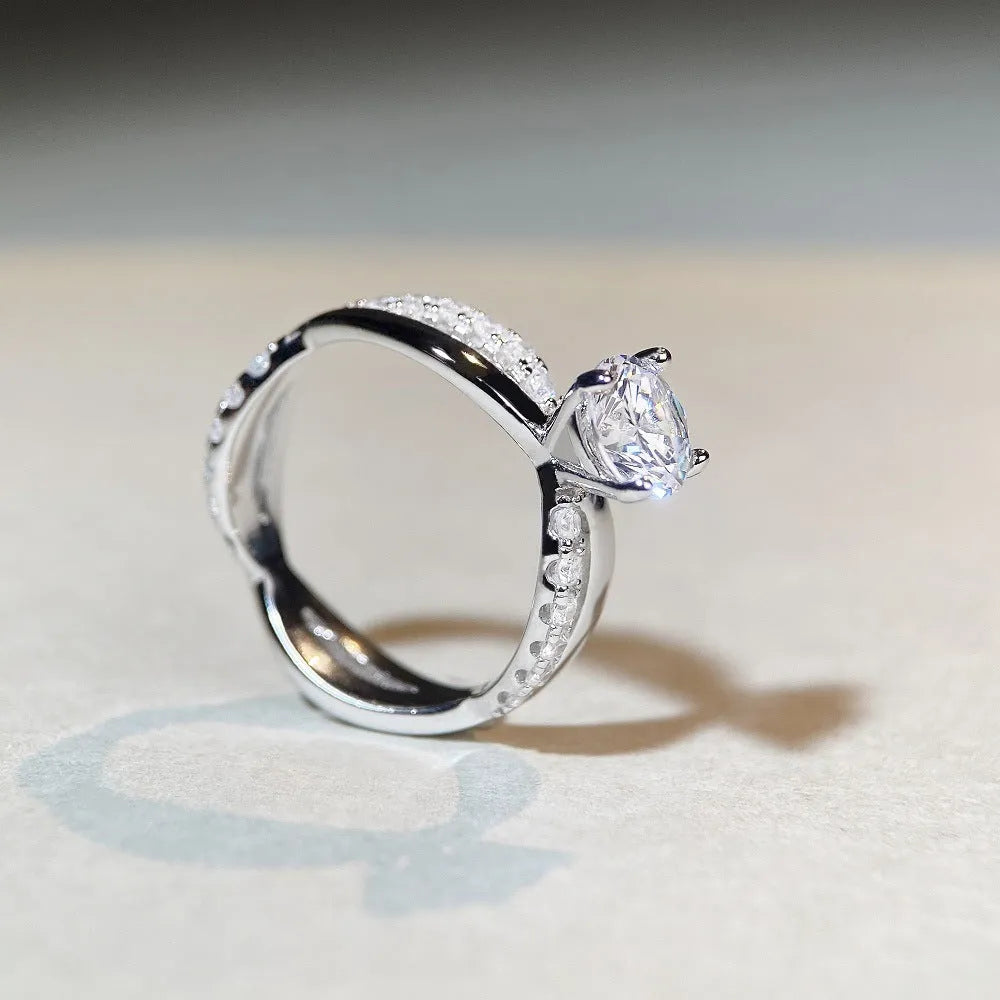 Silver ring with 1 karat moissanite stone in four-claw setting and twisted geometric arms