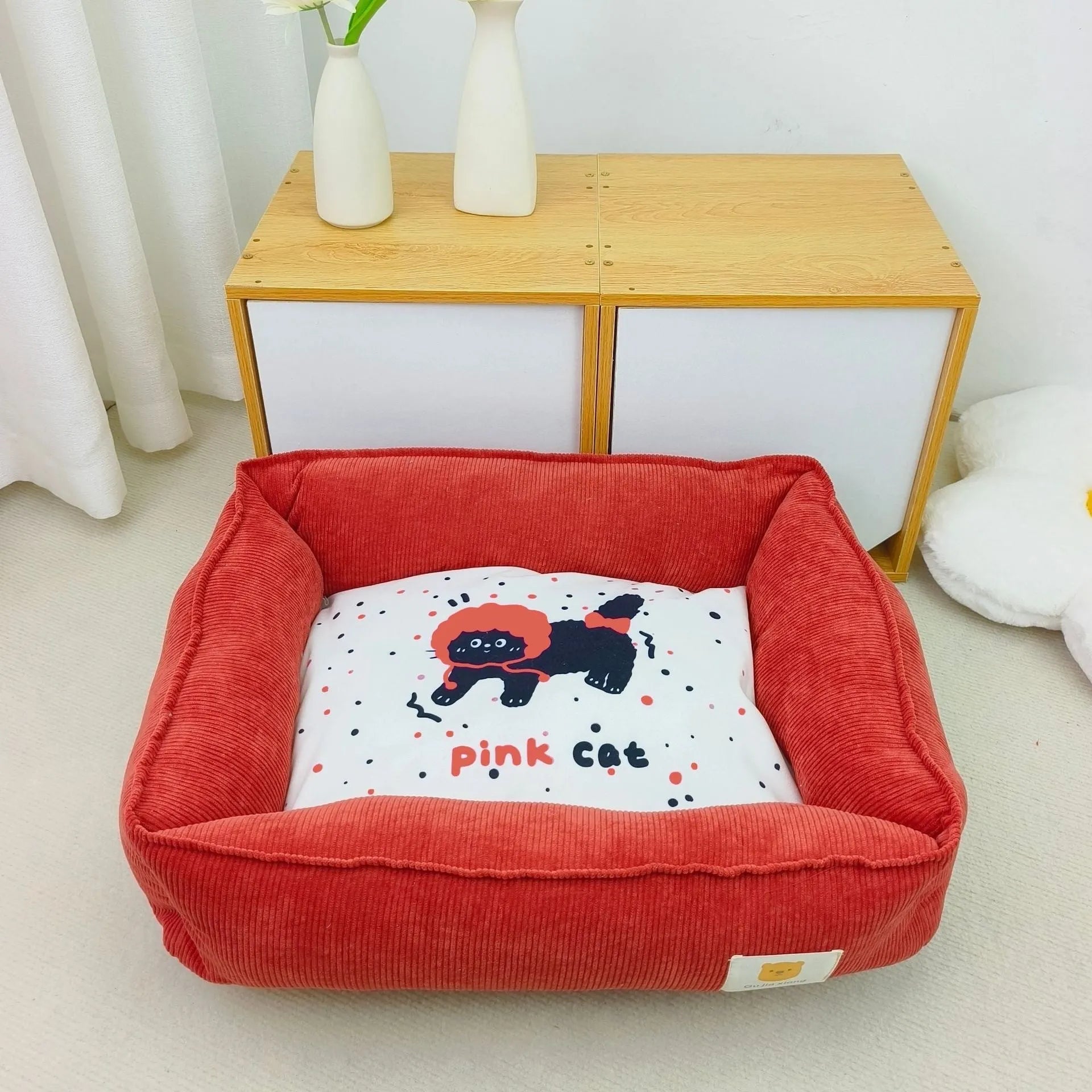 Rectangular cloth pet nest for dogs and cats in a choice of colours, shown in two available sizes.