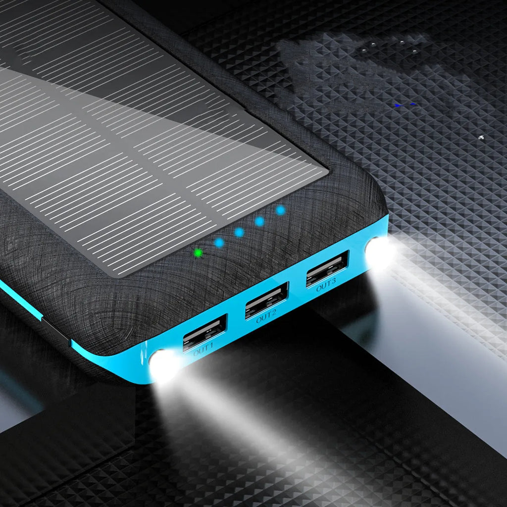 Black portable power bank with wireless Qi charging pad, three USB ports, and LED flashlight