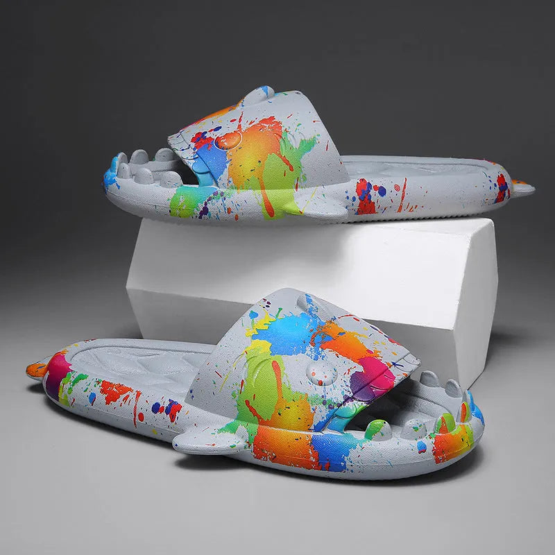 Pair of grey shark design open toe EVA home slippers on a white background.