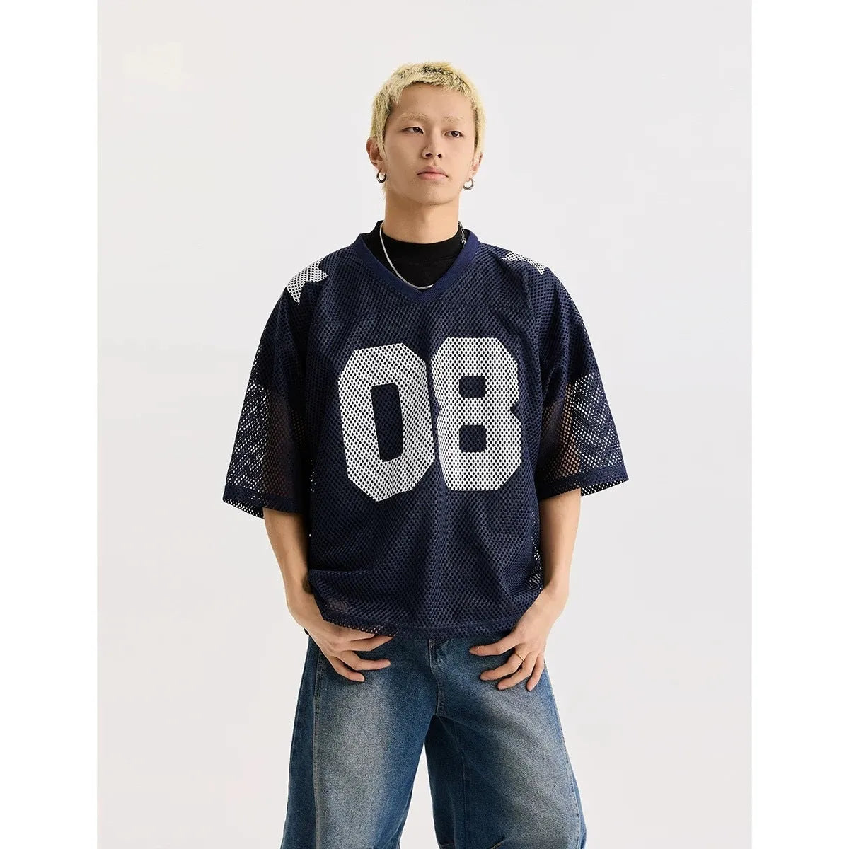 Black polyester pullover shirt with letter pattern design and short sleeves on a hanger