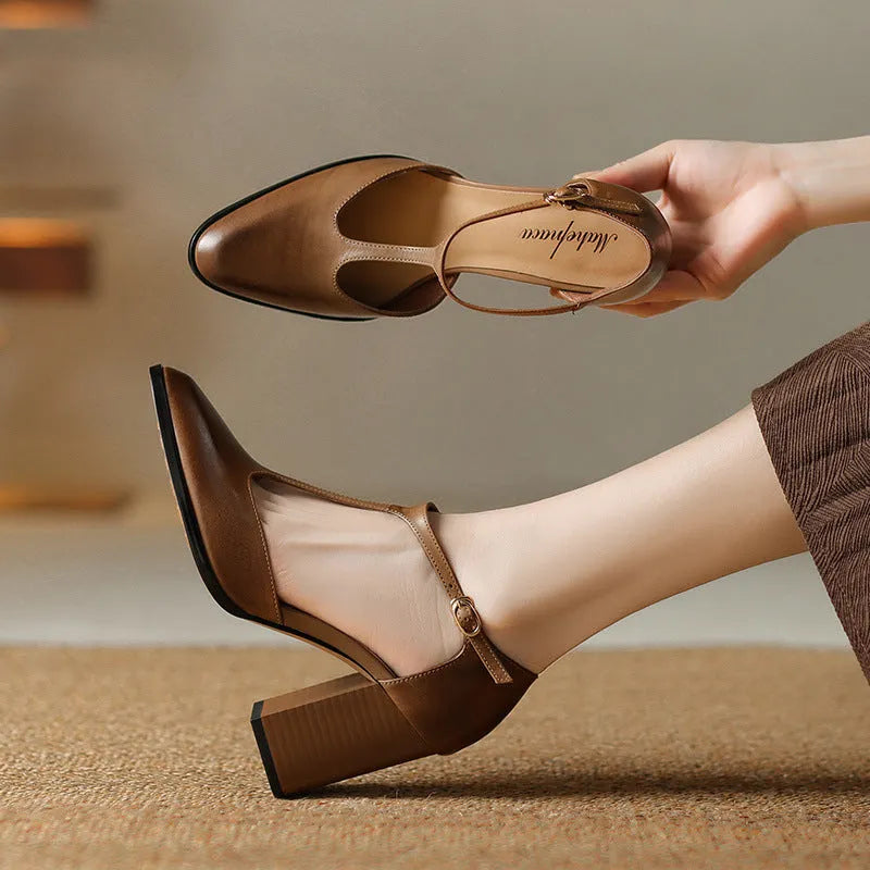 Baotou hollow-cut retro Mary Jane shoes in dark brown with pointed toe and buckle fastening.