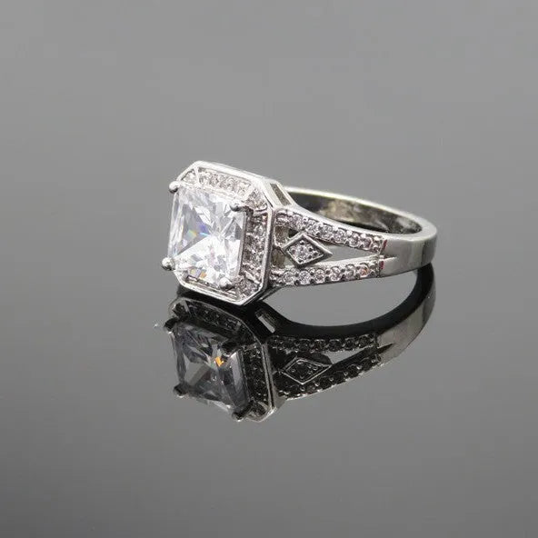 Geometric zircon ring with hollow design in platinum colour on copper, showing quadrilateral pattern and inlaid detailing