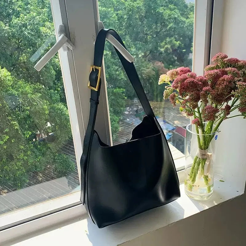 Women's soft PU leather shoulder bag with swing thread details in black or brown, showing dimensions of 28x32x12cm.