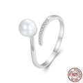 Women's adjustable sterling silver ring with shell pearls and open loop design