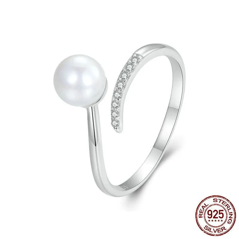 Women's adjustable sterling silver ring with shell pearls and open loop design