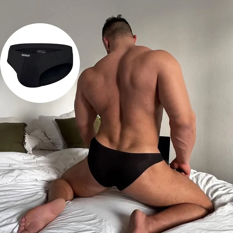 Solid colour men's seamless low waist briefs in black on a white background