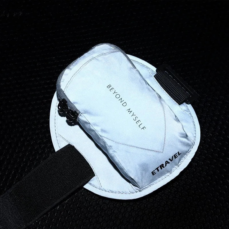 Reflective black running arm band with adjustable strap, shown holding a smartphone.