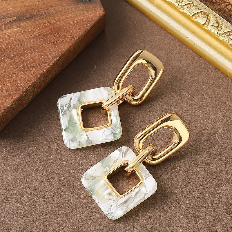 Hollow geometric square earrings with chamfered edges in electroplated copper