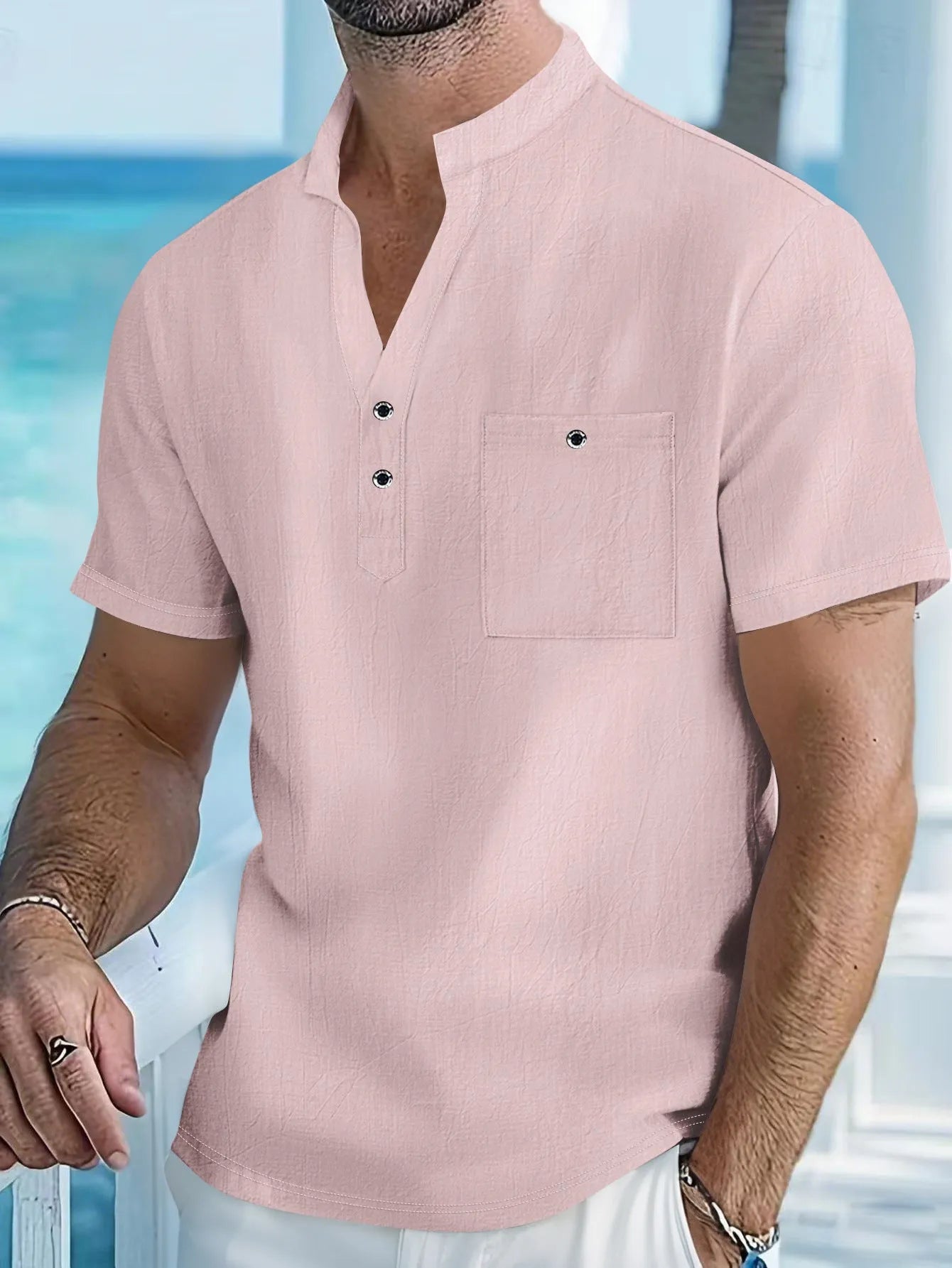 Man's light blue linen blend t-shirt with stand collar and short sleeves in a loose fit.