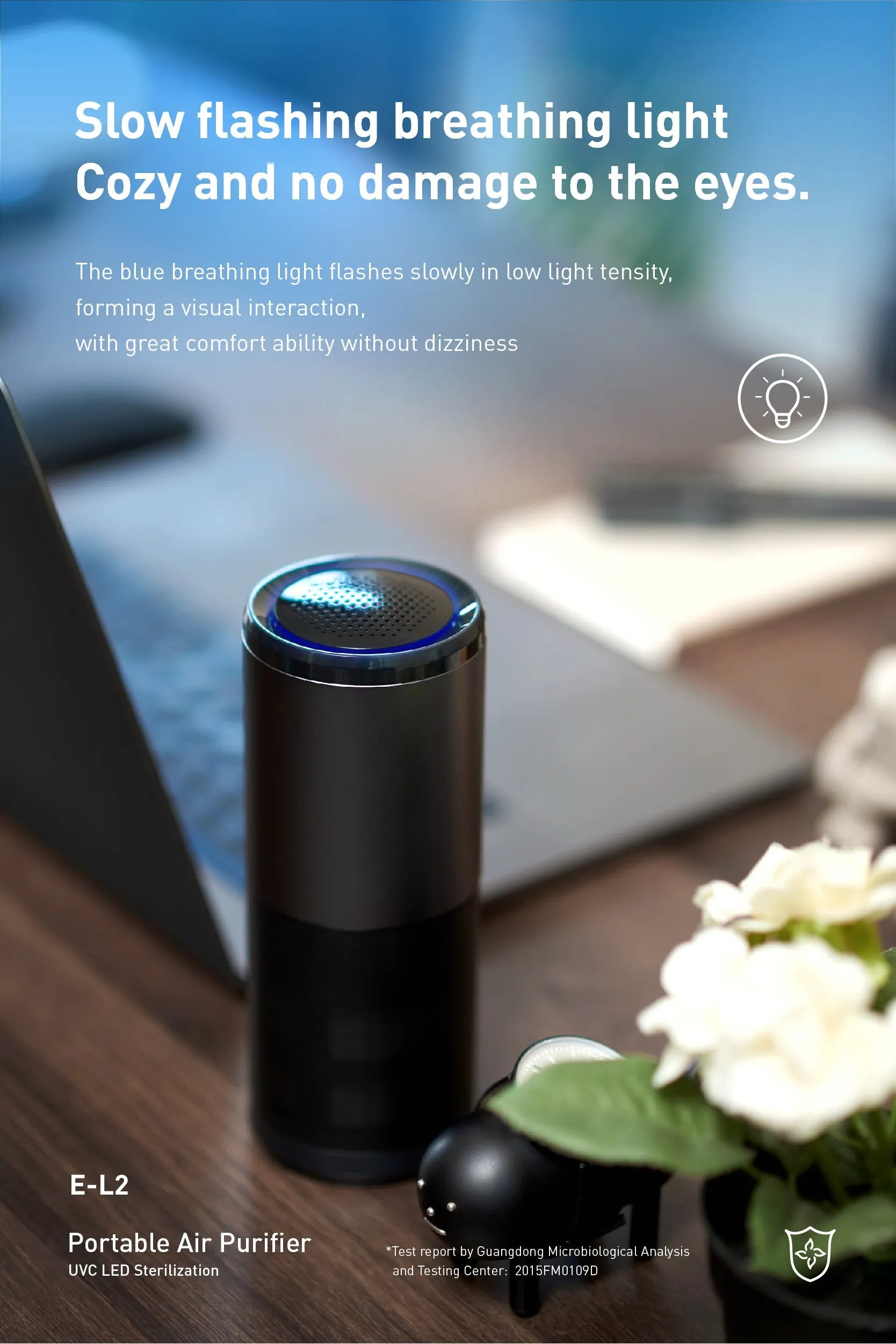Black portable mini car air purifier with USB cable next to a car cup holder.