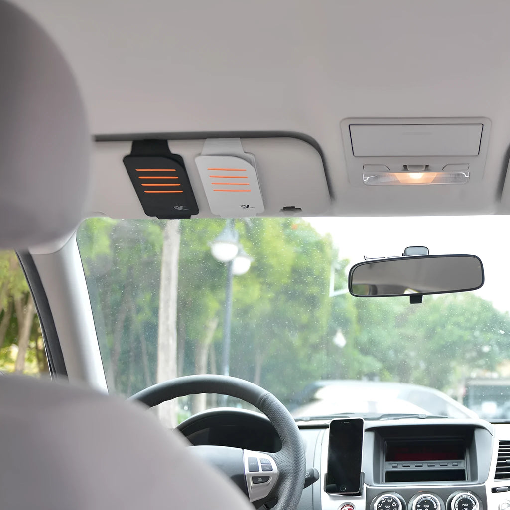Grey car dashboard storage bag with 4 card slots and clear plastic window mounted on vehicle windscreen