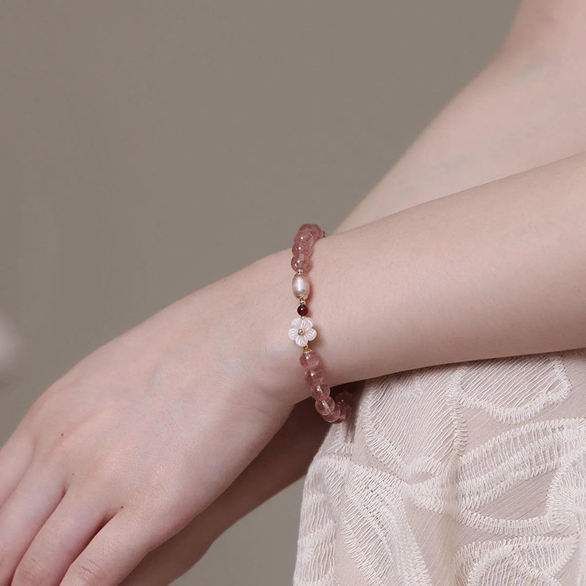 Crystal floral bracelet with strawberry quartz peach blossom colour on wrist