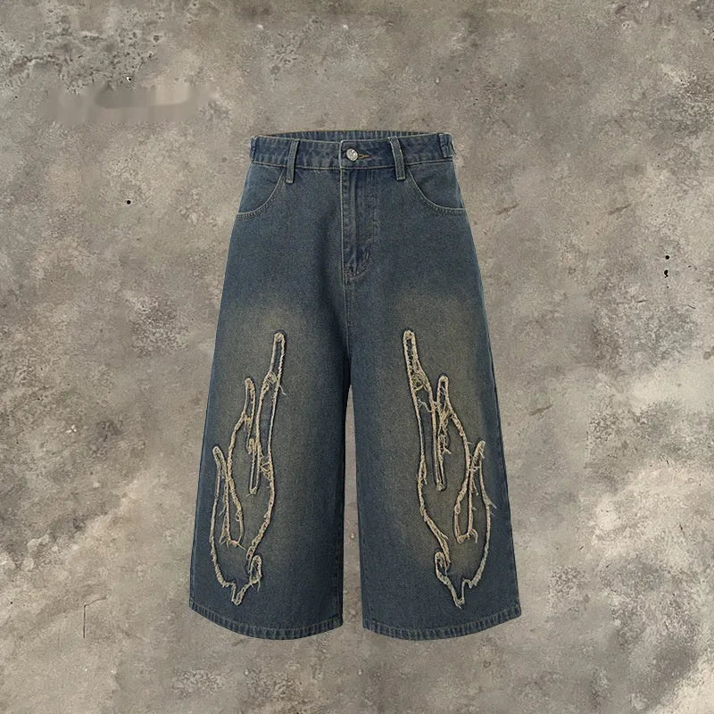 Men's black denim shorts with flame embroidery patch decoration and straight cut cropped design