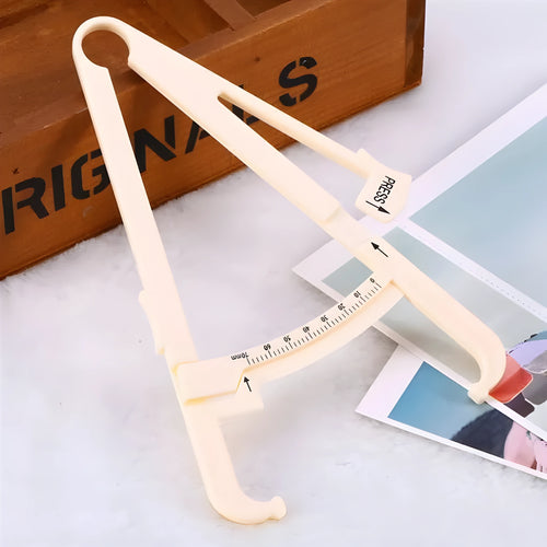 A compact, clear acrylic body fat caliper for measuring skin fold thickness, showing measurement scale.