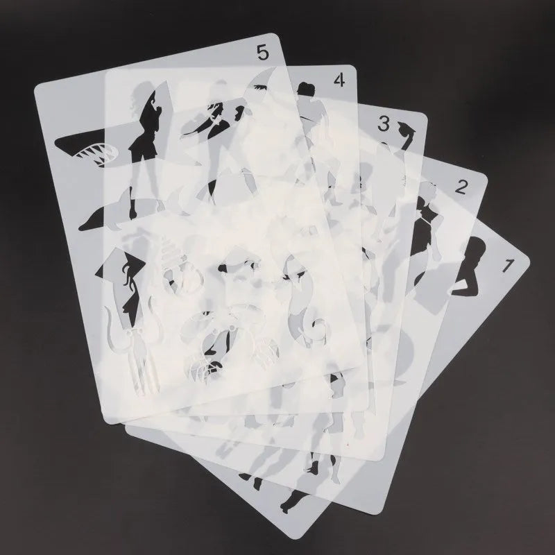 A set of white drawing stencils with various cut-out shapes, laid out on a flat surface.