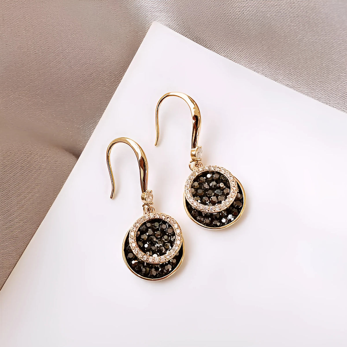 Black geometric alloy drop earrings with round piece design, 3.6cm long.